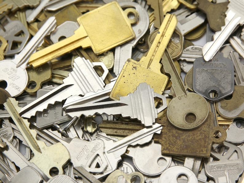 A mix of silver and yellow brass keys. They are in used condition and consist of cut and uncut keys. Types of keys can include, house, file cabinet, padlock, door, car, equipment, and more.  They are great for crafting, and mixed media art projects.