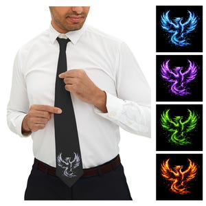 May include: A black necktie featuring a white phoenix graphic at the bottom. The image also displays four square panels showing the same phoenix design in blue, purple, green, and orange colors against a black background.