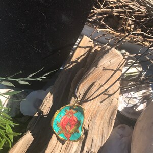 Turquoise pendant with red flower pod