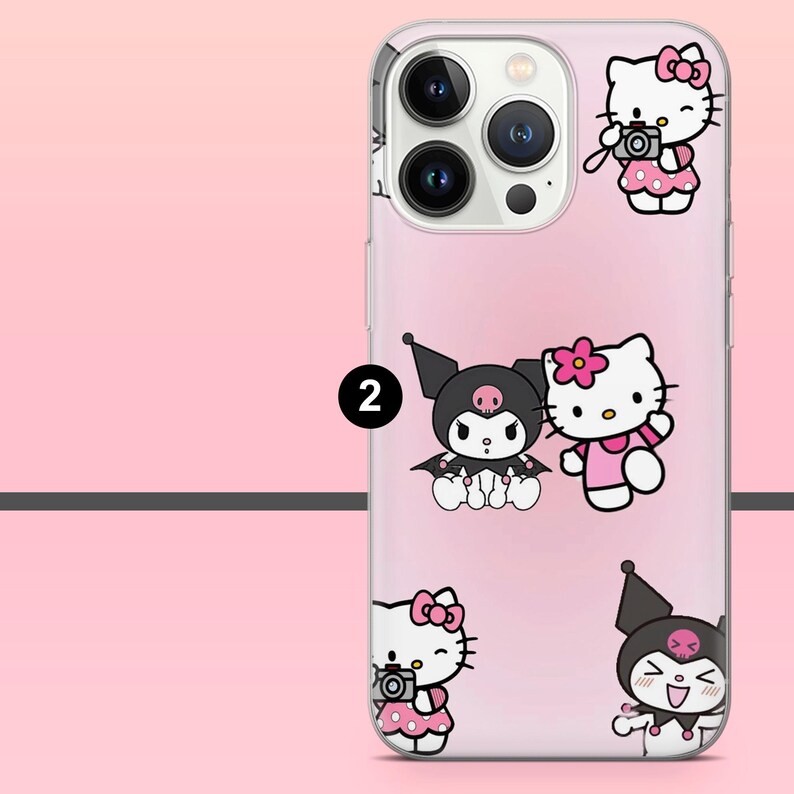 May include: A clear phone case with a pink gradient background featuring cartoon characters. The case has a camera cutout and multiple illustrations of Hello Kitty and Kuromi. Hello Kitty is wearing a pink dress and Kuromi is wearing a black hat.