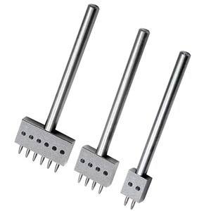 May include: Three silver-colored leathercraft tools with rectangular heads and multiple prongs. Each tool has a long, cylindrical handle. The tools are arranged from largest to smallest, suggesting different stitch spacing options for leatherwork.