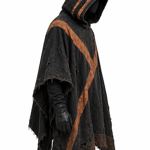 May include: A black hooded poncho with distressed details and brown accents. The poncho features a pointed hood and a cross-shaped design on the front. The sleeves are long, and the edges are frayed.