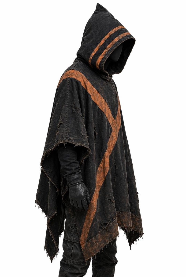 May include: A black hooded poncho with distressed details and brown accents. The poncho features a pointed hood and a cross-shaped design on the front. The sleeves are long, and the edges are frayed.