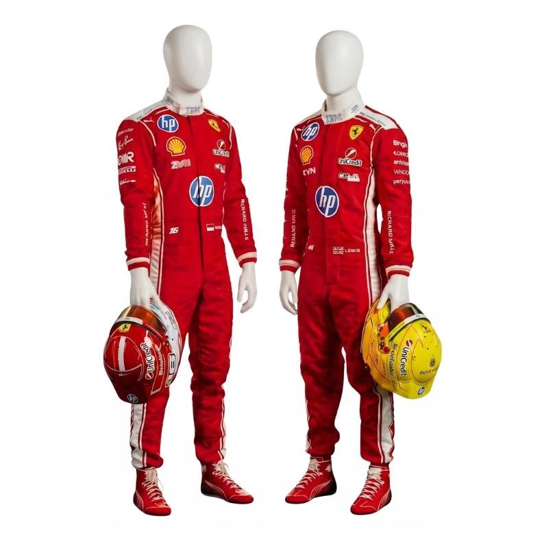 May include: Two mannequins dressed in red racing suits with white detailing and sponsor logos, including HP and Shell. Each mannequin holds a racing helmet, one red and white, the other yellow and black. The suits have long sleeves and are worn with red trainers.