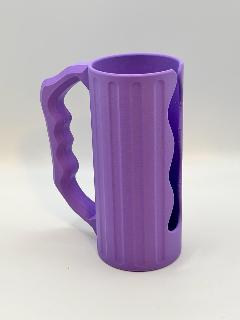 May include: A set of three ceramic mugs with a speckled, matte finish. The mugs are in shades of cream, light gray, and dark gray. Each mug has a simple, minimalist design, perfect for coffee or tea.