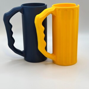 May include: A white ceramic mug with a black handle and the text "But First, Coffee" in a black, handwritten-style font. The mug is on a white surface.