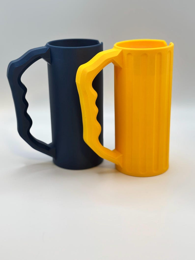 May include: A white ceramic mug with a black handle and the text "But First, Coffee" in a black, handwritten-style font. The mug is on a white surface.
