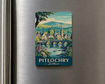 May include: A rectangular magnet featuring a scenic illustration of Pitlochry, Scotland. The image depicts a bridge over a river, buildings, and mountains under a blue sky. Text on the magnet reads "Pitlochry - Scotland."