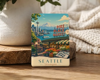 May include: A rectangular magnet featuring a vintage-style illustration of Seattle's Pike Place Market. The image includes the Space Needle, waterfront, and text that reads "Seattle Washington."