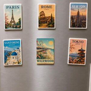a collection of six vintage-style magnets on a refrigerator, each depicting a different city from around the world.