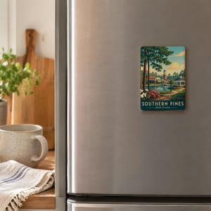 a refrigerator with a Southern Pines magnet on it, along with various kitchen items such as a coffee mug, a wooden cutting board, and a bowl of fruit.