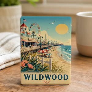 A framed print of a beach scene with a ferris wheel, beach, and ocean in the background, along with the text "WILDWOOD, NJ" at the bottom.