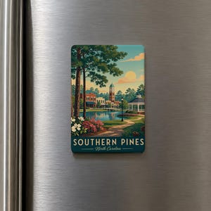 A vintage-style magnet depicting a scenic view of Southern Pines, North Carolina, with a lake, trees, and buildings in the background.