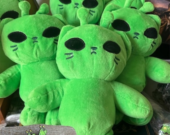 Green Alien Cat Plush Toy 9.8 inches tall. Get a free Green Alien Cat Pin with every purchase. Perfect gift for any occasion.