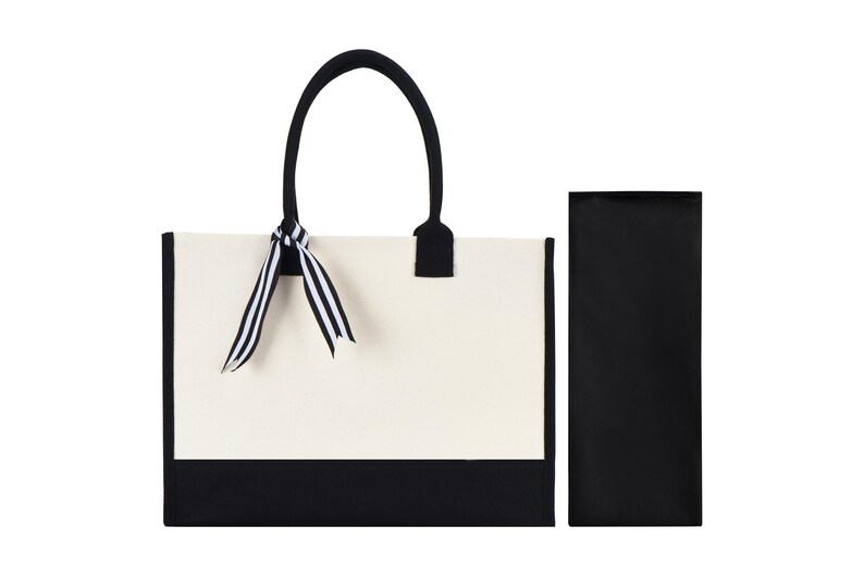 a black and white bag with a bow on it