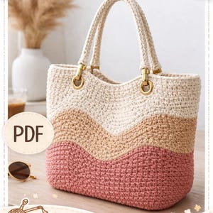 Könnte beinhalten: Häkelhandtasche mit Zickzackmuster in Creme-, Beige- und Rosatönen. Die Tasche hat eine rechteckige Form, goldfarbene Beschläge und cremefarbene Griffe. Der Text "CROCHET PATTERN" und "Crochet Handbag" ist zu sehen.