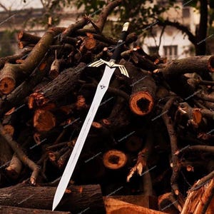 May include: A silver and black sword with a decorative gold hilt and a long, pointed blade. The sword is displayed against a backdrop of stacked, dark brown logs, creating a rustic and dramatic contrast.