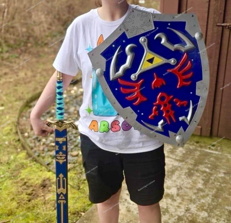 May include: A blue and silver shield with red and yellow accents, and a matching blue and gold sword. The shield has a silver border and a blue center with a yellow triangle and red designs. The sword has a blue blade and a gold hilt.