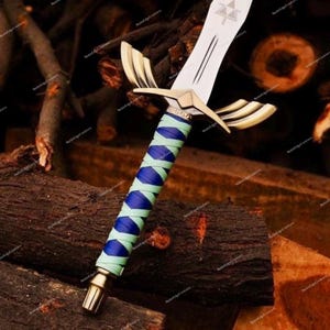 May include: A decorative sword with a silver blade and gold accents. The handle is wrapped in blue and light green material. The sword features a gold crossguard with a wing design. The blade has a triangle symbol.