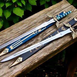 May include: Two decorative swords with silver blades and gold accents rest on a wooden surface. One sword has a blue and gold handle and sheath, while the other has a black sheath and handle. The swords are likely for cosplay or display.