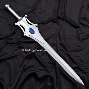 May include: A silver sword with a blue gem in the center of the hilt. The sword has a long, pointed blade and a decorative handle. The text "NobleEdgeCreations" is printed on the blade.