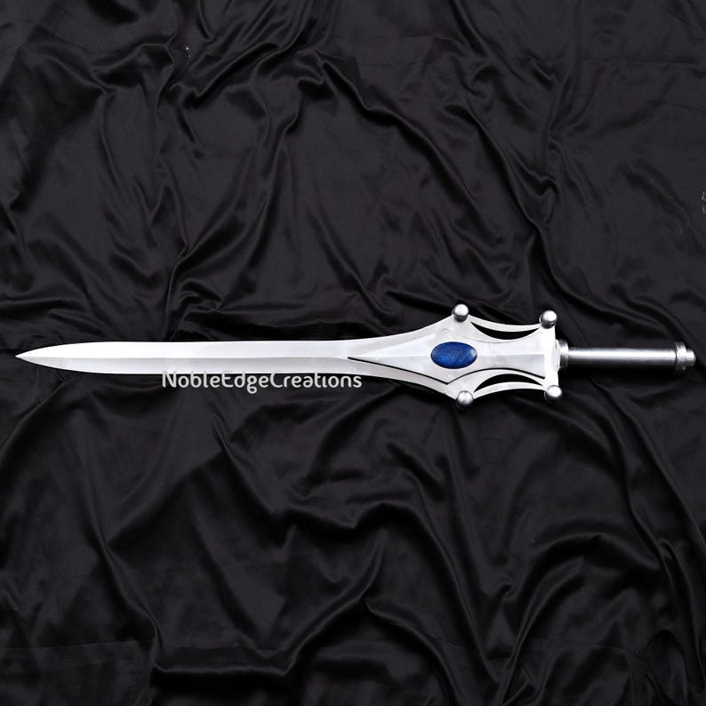 May include: A silver sword with a pointed blade and a decorative hilt featuring a blue gem. The text "NobleEdgeCreations" is printed on the blade. The sword is displayed against a black background.
