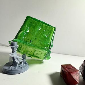 May include: A white ceramic mug with a black handle and the text "But First, Coffee" in a bold, black font. The mug is set against a neutral background, highlighting its simple design.