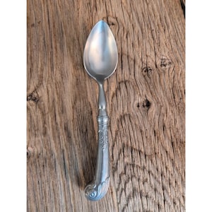 May include: A set of three ceramic mugs with a speckled, matte finish. Each mug features a different color: light blue, cream, and gray. The mugs have a simple, modern design with a rounded shape and a handle.