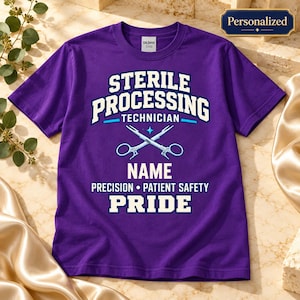 May include: A purple short-sleeve t-shirt featuring white and light blue text that reads Sterile Processing Technician, Name, Precision, Patient Safety, Pride, and a graphic of crossed surgical instruments in the center.