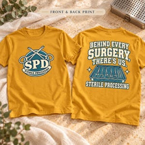 May include: Mustard yellow t-shirt with front and back prints. The front features a blue circle with crossed surgical scissors and the text SPD STERILE PROCESSING. The back displays a tray of surgical tools and the text BEHIND EVERY SURGERY THERE'S US STERILE PROCESSING.