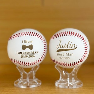 May include: Two white baseballs with red stitching, each resting on a clear acrylic stand. The left ball features the name Oliver, a bow tie icon, the word GROOMSMAN, and the date 25.09.2026. The right ball features the name Justin, Best Man, and 05-12-2026.