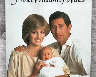 May include: A hardcover book titled Born to Be King Prince William of Wales by Trevor Hall. The cover features a photograph of a family of three, with text detailing over 330 photographs, the Princess of Wales, and the christening of the prince.