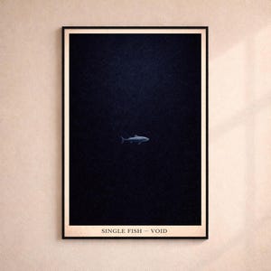 May include: Framed art print featuring a single fish swimming in a dark blue void. The fish is light blue and the text "SINGLE FISH - VOID" is printed at the bottom of the print.