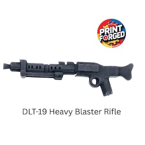May include: A black DLT-19 Heavy Blaster Rifle, a replica firearm, is shown against a white backdrop. The rifle has a detailed design with a barrel, grip, and stock. The text "DLT-19 Heavy Blaster Rifle" is below the rifle.