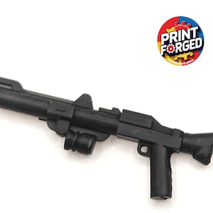 May include: A white ceramic mug with a black handle and the text "But First, Coffee" in a black, handwritten-style font. The mug is on a white surface.