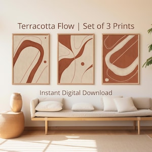 Puede incluir: Un conjunto de tres láminas de arte mural enmarcadas tituladas Terracotta Flow, con formas y líneas orgánicas abstractas en color terracota y crema. El texto dice Terracotta Flow | Set of 3 Prints e Instant Digital Download.