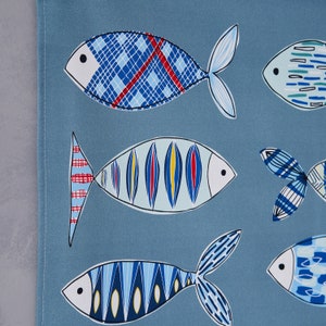 May include: A blue background with colorful fish designs. The fish are all different shapes and sizes and have various patterns. Some of the fish have red, yellow, and blue stripes, while others have a plaid pattern.