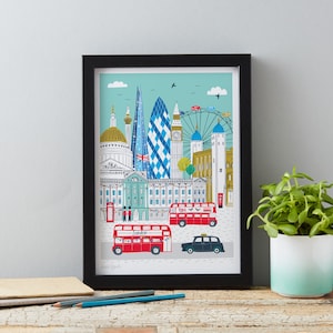May include: A framed print of a colorful illustration of London landmarks, including Big Ben, the London Eye, and red double-decker buses. The print has a blue and green background and the text "London" is visible.
