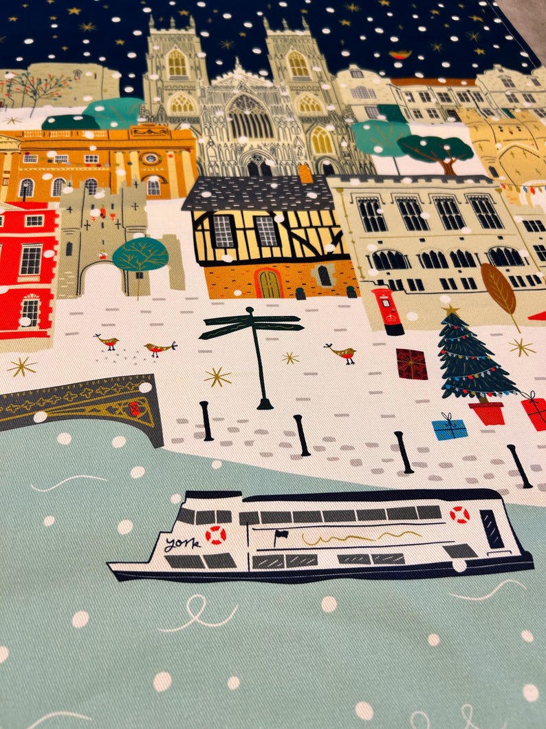May include: A festive illustration of a snowy cityscape with a river and a boat. The scene features a church, buildings, a Christmas tree, and a signpost. The boat is labeled "York" and has a red life ring. The illustration is in a cartoon style with bright colors.