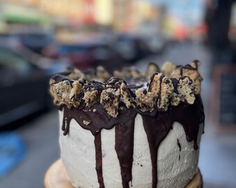 Vegan chocolate vanilla buttercream cherry filling dark chocolate cake with chocolate chip cookies 8”!