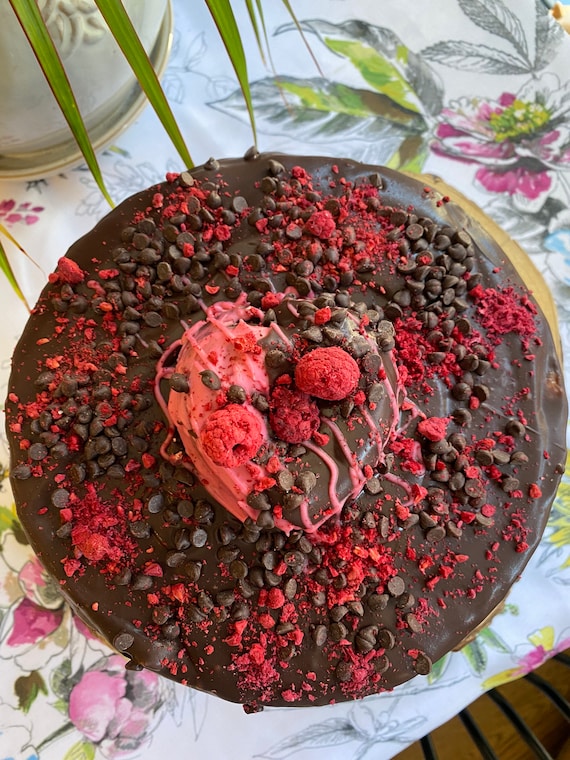 Vegan chocolate vanilla raspberry chocolate chip  cake with heart donut on the top 8”