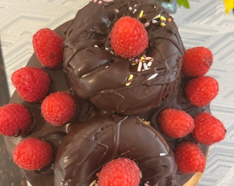 6” Vegan gluten free chocolate vanilla raspberry cake with vegan gluten free donuts on the top