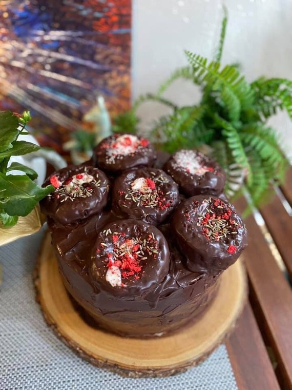 Vegan chocolate vanilla cream raspberry lavender cake with donuts on the top 8”!