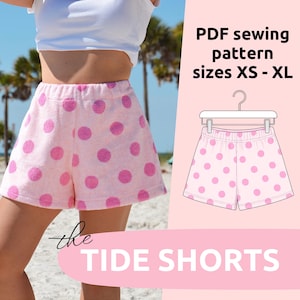 May include: Pink shorts with large magenta polka dots. The shorts are shown on a person and also as a PDF sewing pattern. The text on the image says "PDF sewing pattern sizes XS-XL" and "the TIDE SHORTS".