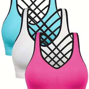 May include: Three sports bras in a row, each with a unique color. The first is light blue, the second is white, and the third is pink. Each bra has a black crisscross design on the back and a seamless design.