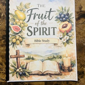 May include: A spiral-bound Bible study book titled "The Fruit of the Spirit." The cover features watercolour illustrations of various fruits, a cross, an open book, and a lit candle. The title is in elegant script.
