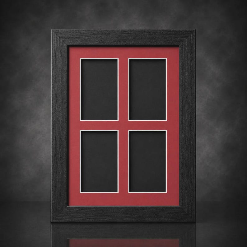 May include: A black multi-aperture picture frame with a red mat and white borders. The frame holds four rectangular openings for photos. The frame is made of wood and has a matte finish. The overall design is simple and elegant.