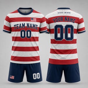 May include: A sports jersey and shorts set featuring red and white horizontal stripes with a subtle list of US states. The jersey displays the text TEAM NAME and 00, while the back shows YOUR NAME and 00 with the text 50 STATES ONE NATION.
