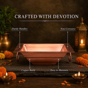 May include: A copper-toned square bowl with sturdy handles, labeled "Crafted with Devotion." The bowl is non-corrosive and easy to maintain. The copper build is highlighted. The bowl is surrounded by candles and flowers.