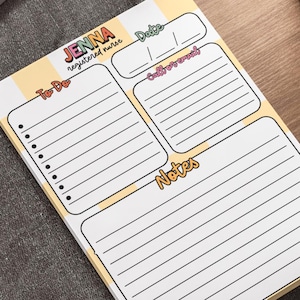 May include: A rectangular notepad with a yellow and white checkered background. The top features the text 'JENNA registered nurse' and a date field. Below are three sections labeled 'To-Do' with bullet points, 'Call/Email' with lines, and 'Notes' with lines.